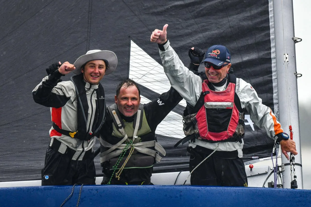 Rosey Yacht Club crew celebrating aboard a racing sailboat